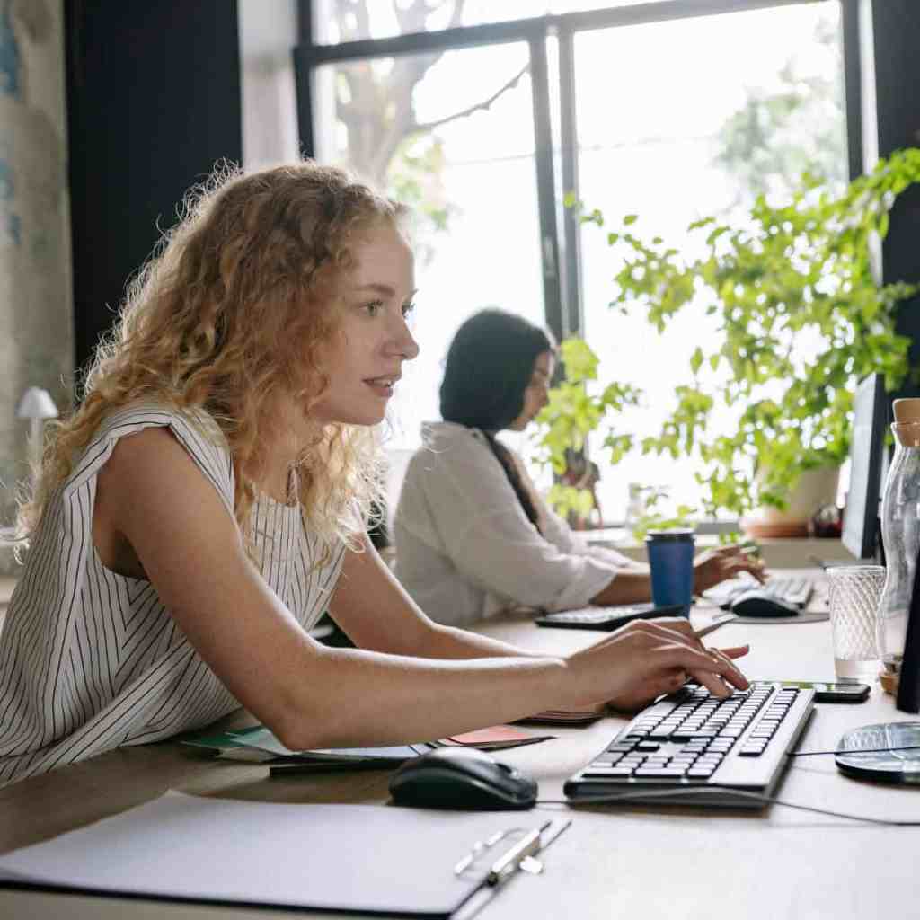 Insurance agency employee using health insurance software to manage client records and daily policy administration tasks.