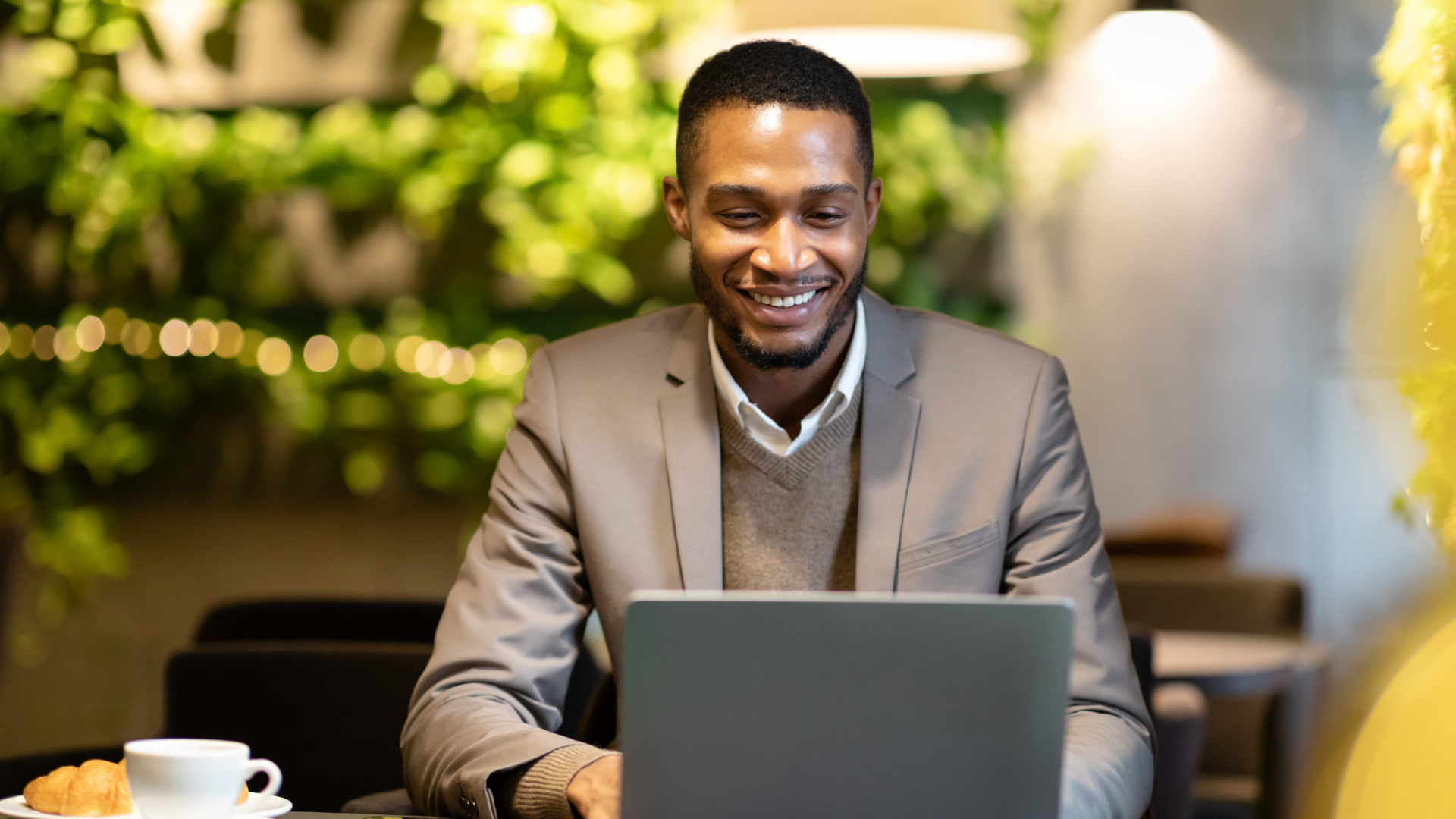 Insurance professional reviewing policy and client information on a laptop in a modern workspace